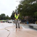 A worker spraying the new pink plinth