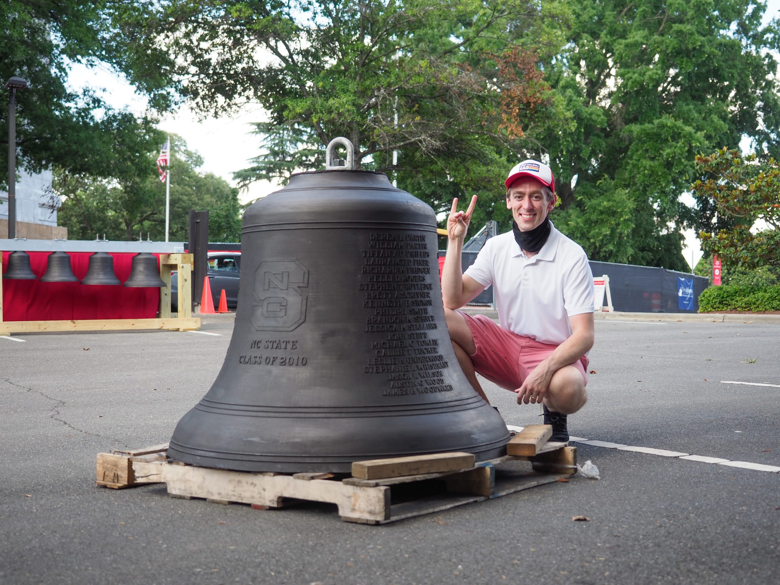 Dr. Stafford poses proudly with the bell engraved in his honor