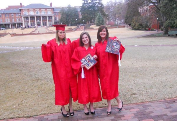 A 2010 photo of 3 female grads with their caps and gowns