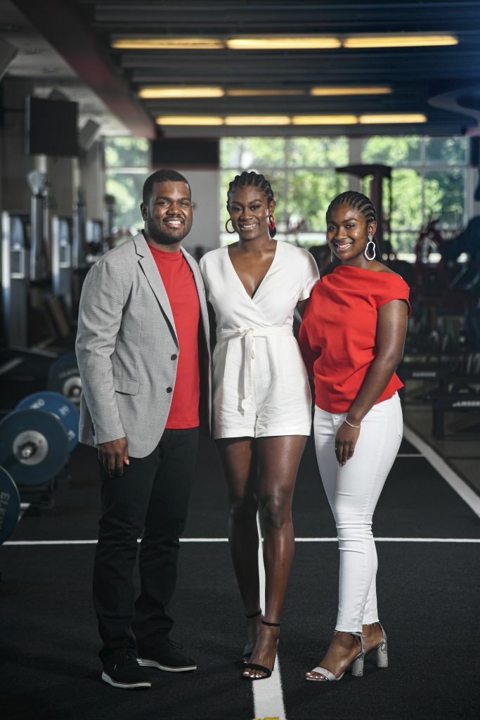 DJ, Demi and Delaney Washington posed together in the football weight room